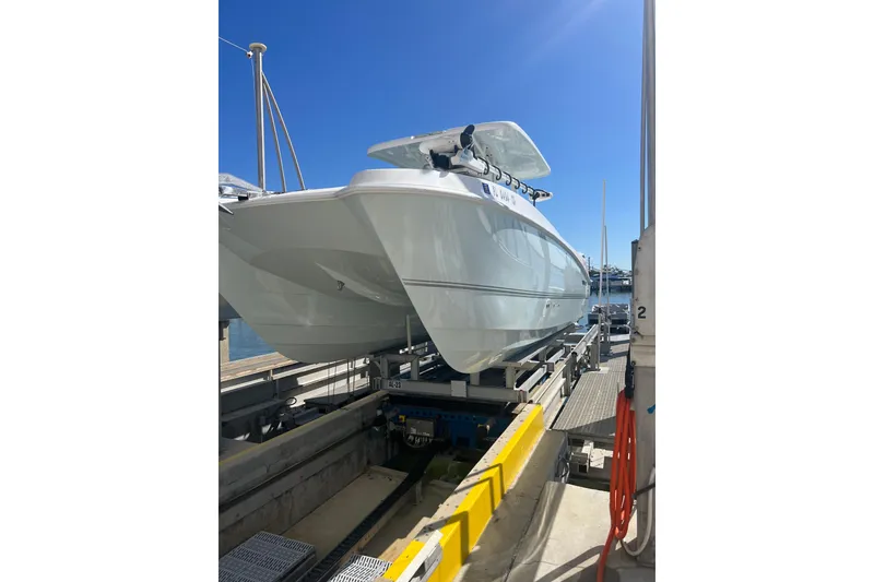 Slide: The Image of 2022 Twin Vee 280 GFX CC boat on dock under clear blue sky. - 5