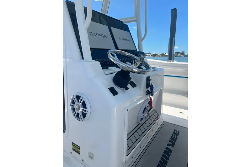Slide: The Image of 2022 Twin Vee 280 GFX CC boat console with Garmin displays and steering wheel. - 7