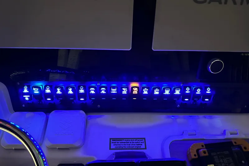 Slide: The Image of Control panel of 2022 Twin Vee 280 GFX CC boat with illuminated switches. - 8