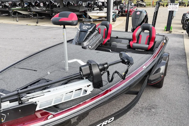 Slide: The Image of 2025 Nitro Z20 XL Pro fishing boat with red and black seats, parked outdoors. - 124