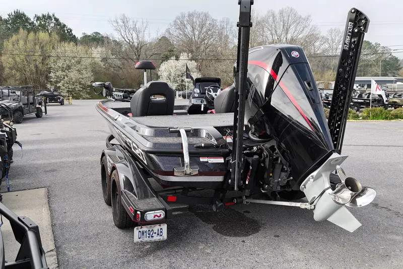 Slide: The Image of 2025 Nitro Z20 XL Pro boat with powerful outboard motor in a parking lot. - 2