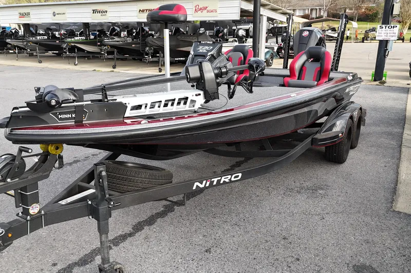 Slide: The Image of 2025 Nitro Z20 XL Pro fishing boat with Minn Kota motor, parked on a trailer. - 4