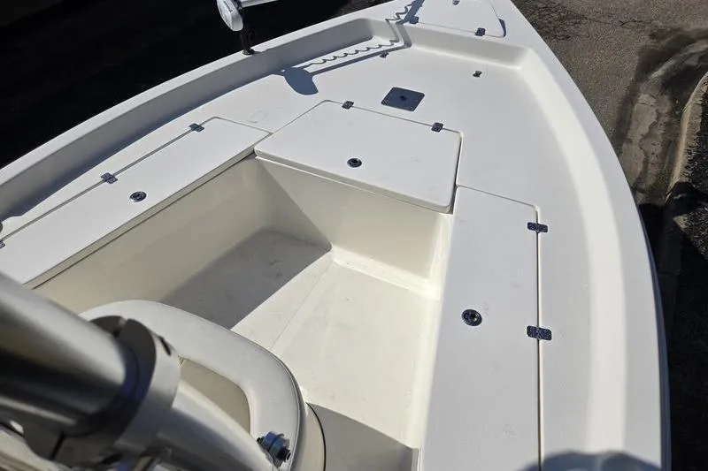 Slide: The Image of 2022 Bulls Bay 2200 boat deck with storage compartments and clean white finish. - 10