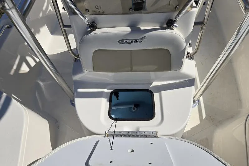 Slide: The Image of 2022 Bulls Bay 2200 boat interior with seating and storage compartment. - 11