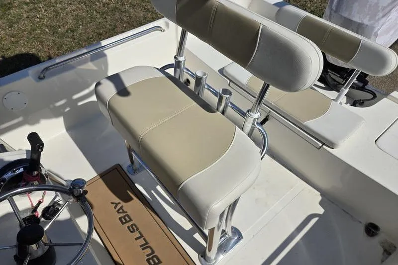 Slide: The Image of 2022 Bulls Bay 2200 boat interior with beige seating and steering wheel. - 13