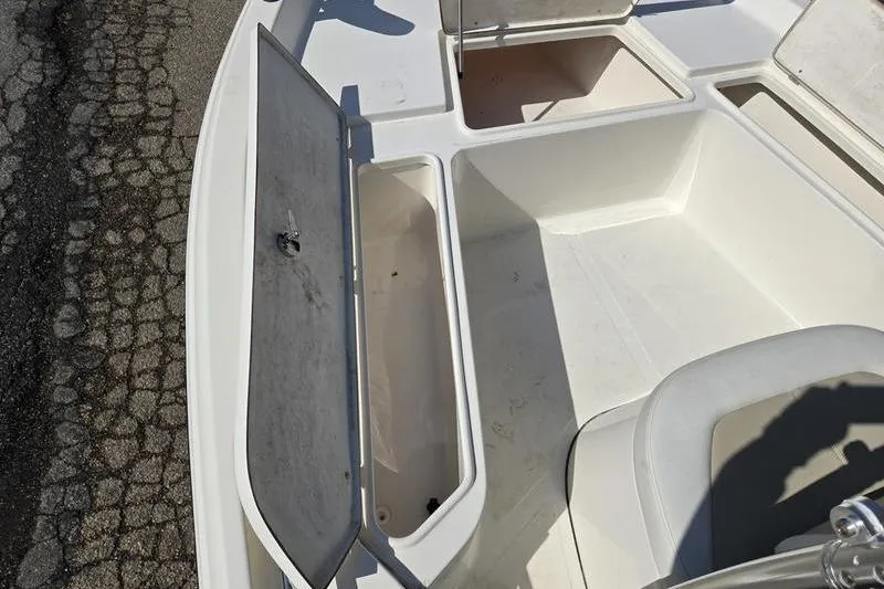 Slide: The Image of 2022 Bulls Bay 2200 boat storage compartments with open hatches, showcasing interior space. - 14