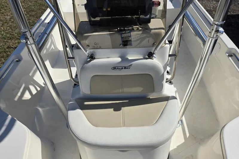Slide: The Image of 2022 Bulls Bay 2200 boat interior with seating and console, featuring chrome details. - 15