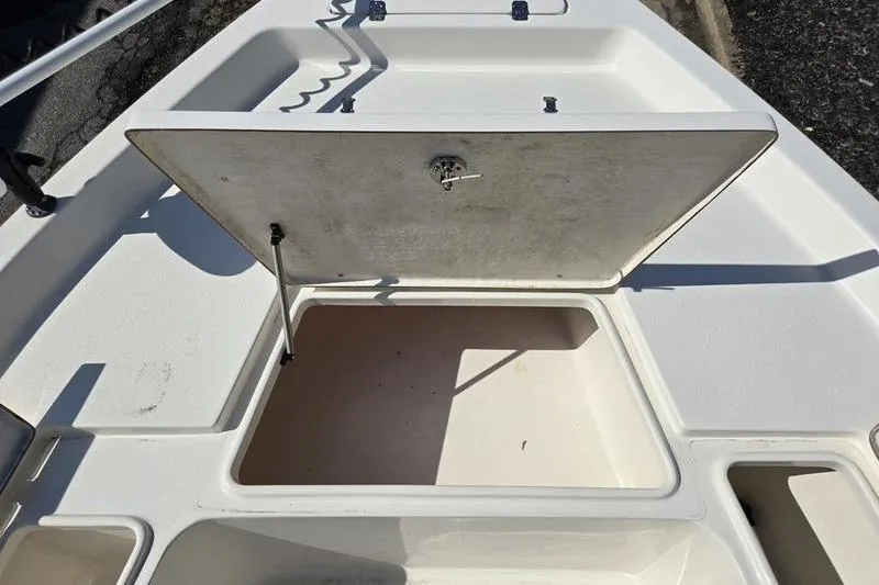 Slide: The Image of 2022 Bulls Bay 2200 boat storage compartment with open hatch, showcasing interior space. - 16