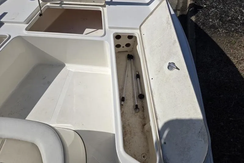 Slide: The Image of 2022 Bulls Bay 2200 boat storage compartments with open hatches and visible rods. - 17
