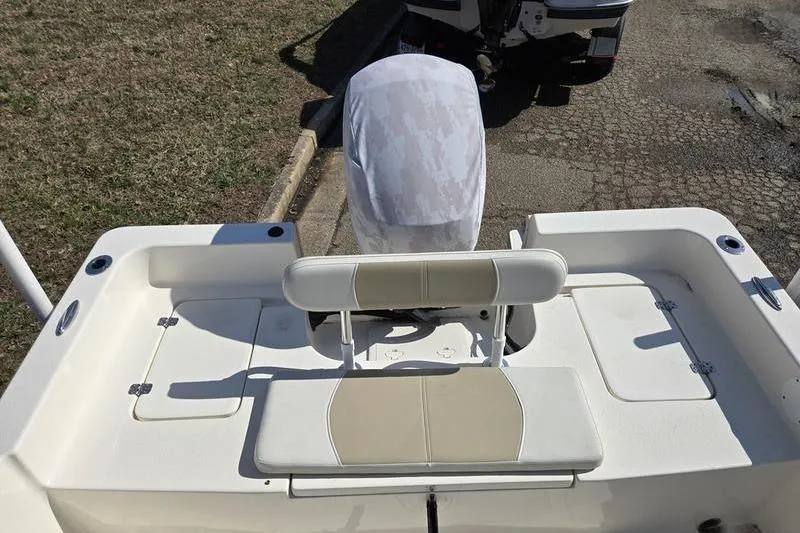 Slide: The Image of 2022 Bulls Bay 2200 boat with covered outboard motor and seating area. - 5
