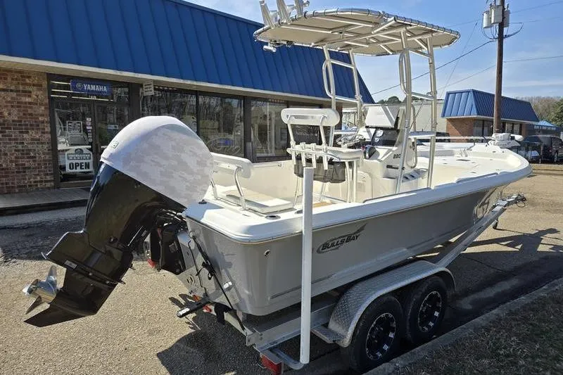 Slide: The Image of 2022 Bulls Bay 2200 boat on trailer, parked outside a dealership. - 6