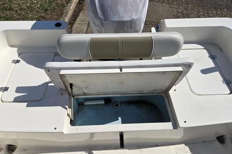 Slide: The Image of 2022 Bulls Bay 2200 boat with open storage compartment and cushioned seating. - 7