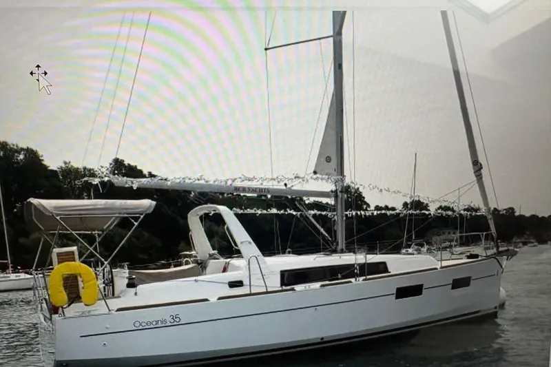 Slide: The Image of 2015 Beneteau Oceanis 35 sailboat docked at a marina, sunny day. - 2