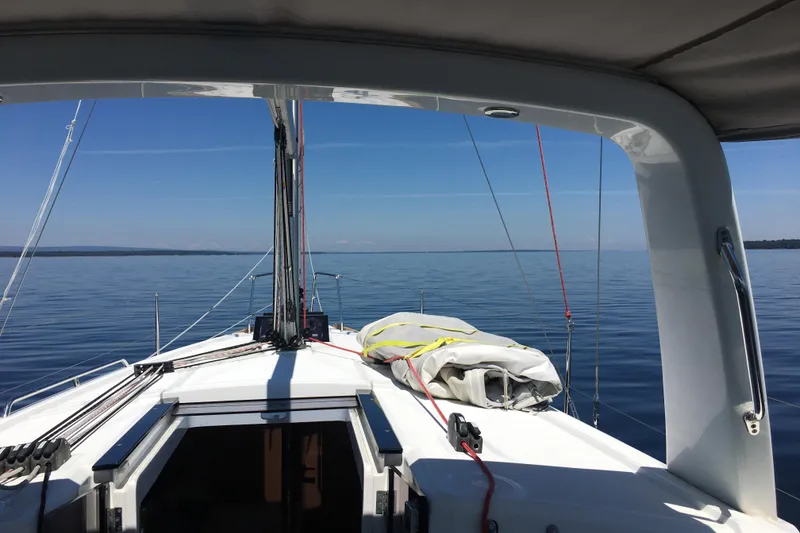 Slide: The Image of 2015 Beneteau Oceanis 35 sailboat on calm waters under clear blue sky. - 8