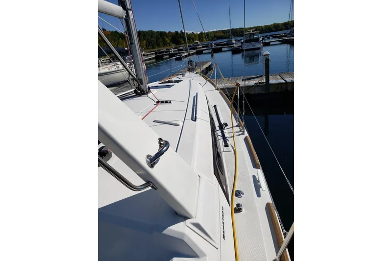 Slide: The Image of 2015 Beneteau Oceanis 35 sailboat docked at a marina under clear blue skies. - 9