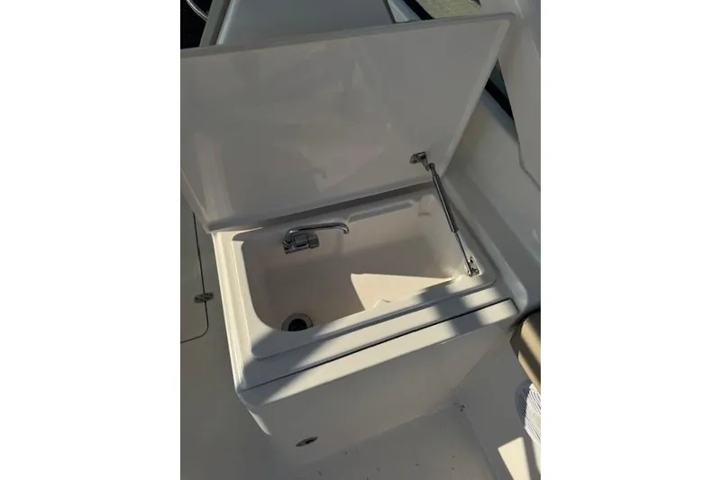 Slide: The Image of Open sink compartment on 2015 Pursuit DC 265 Dual Console boat. - 9