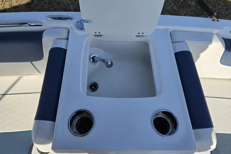 Slide: The Image of 2024 Tahoe 2150 boat interior with sink and cup holders. - 11