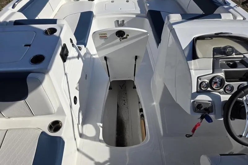 Slide: The Image of 2024 Tahoe 2150 boat interior with seating, storage, and control panel. - 13