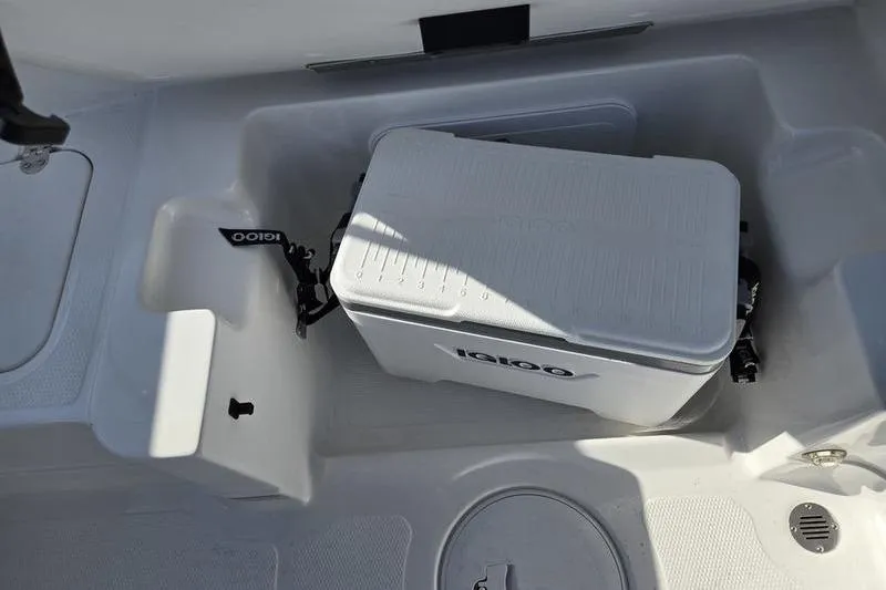 Slide: The Image of 2024 Tahoe 2150 boat interior with Igloo cooler in storage compartment. - 17