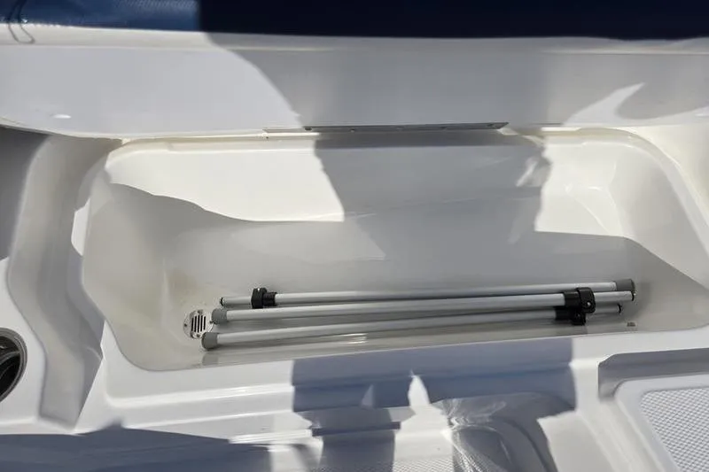 Slide: The Image of 2024 Tahoe 2150 boat storage compartment with metal poles inside. - 18
