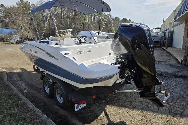 Slide: The Image of 2024 Tahoe 2150 boat on trailer with outboard motor and canopy. - 2