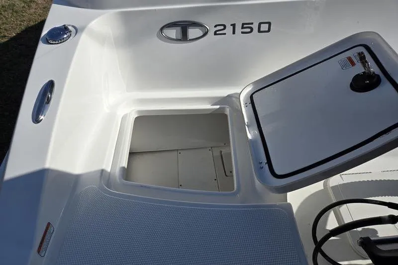 Slide: The Image of 2024 Tahoe 2150 boat storage compartment with open hatch, showcasing interior space. - 7