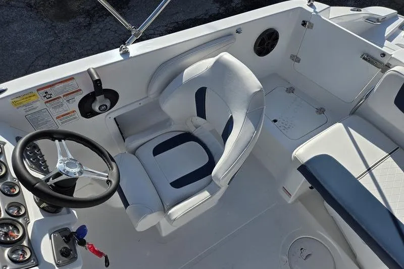 Slide: The Image of 2024 Tahoe 2150 boat interior with steering wheel and seating area. - 9
