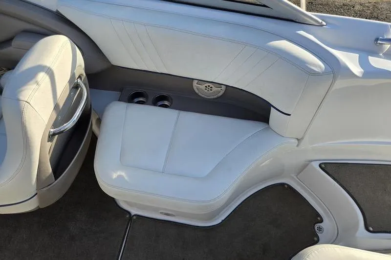 Slide: The Image of Interior of a 2006 Cobalt 232 boat with white seating and cup holders. - 11