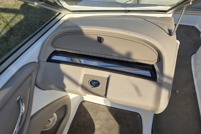 Slide: The Image of 2006 Cobalt 232 boat interior with glove compartment and speaker. - 13