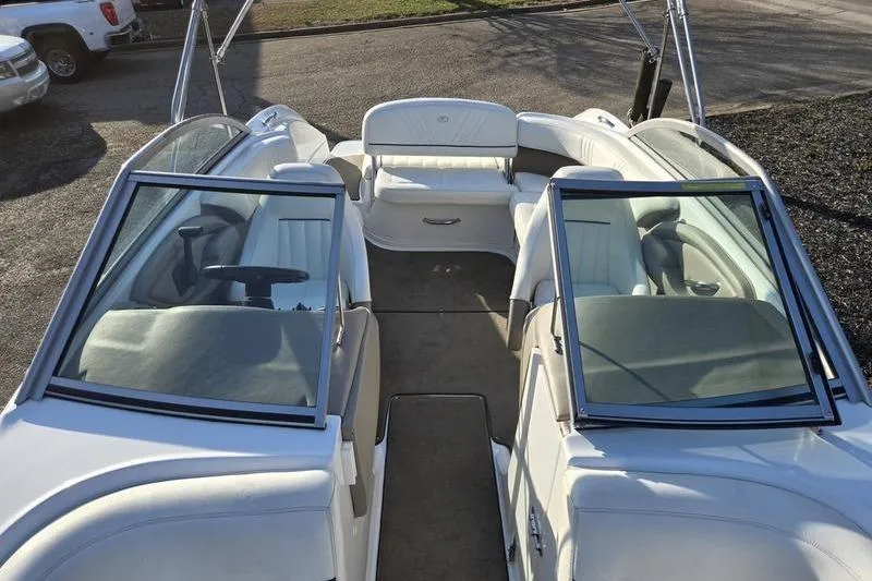 Slide: The Image of 2006 Cobalt 232 boat interior with white seating and open windshield. - 18