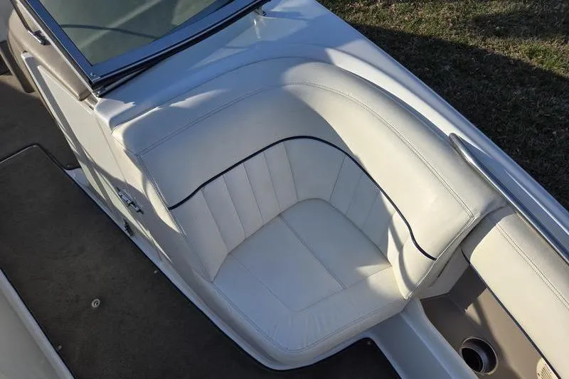 Slide: The Image of 2006 Cobalt 232 boat interior with white leather seating and sleek design. - 19