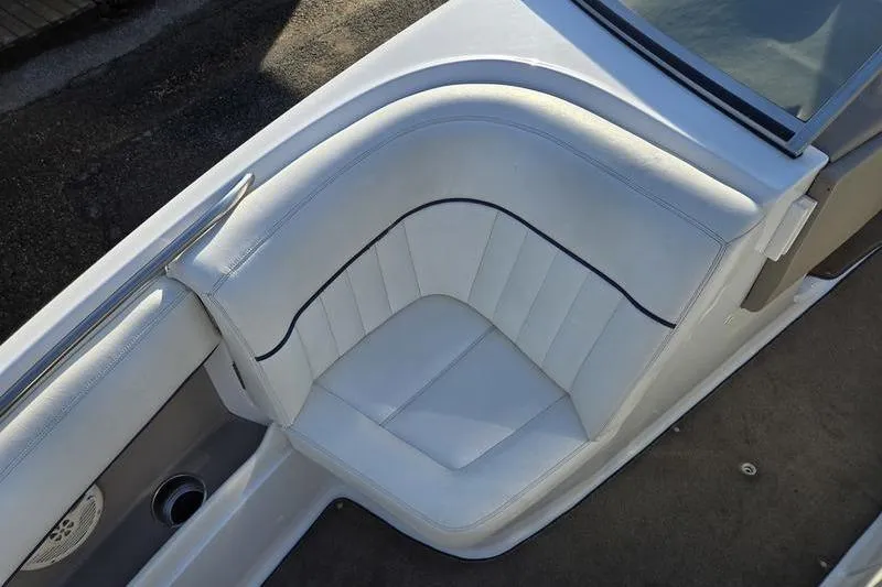 Slide: The Image of White leather seating in a 2006 Cobalt 232 boat, showcasing elegant design. - 21