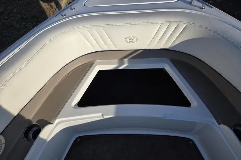 Slide: The Image of Interior view of a 2006 Cobalt 232 boat, featuring cushioned seating and storage area. - 22