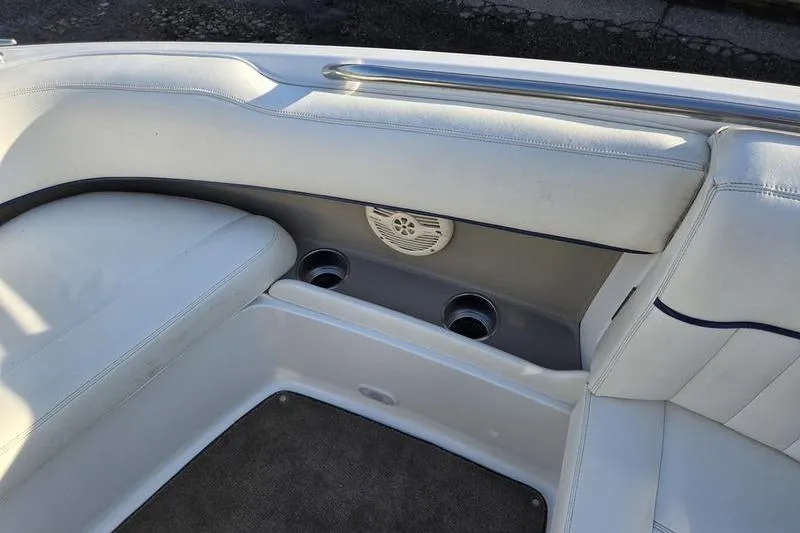 Slide: The Image of Interior of a 2006 Cobalt 232 boat with white seating and cup holders. - 23