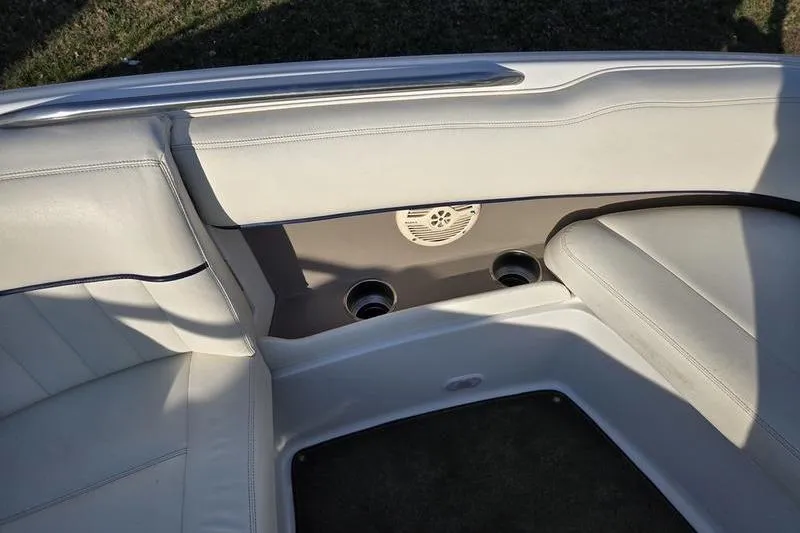Slide: The Image of Interior seating of a 2006 Cobalt 232 boat with cup holders and speaker. - 24