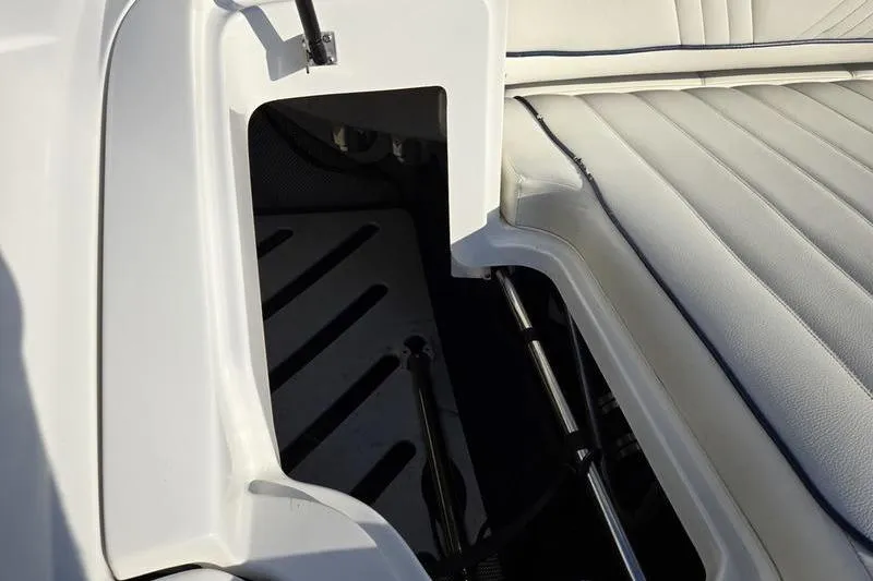 Slide: The Image of Interior view of a 2006 Cobalt 232 boat, showcasing white seating and storage compartment. - 4