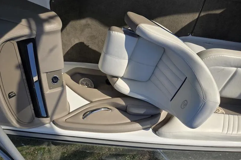 Slide: The Image of 2006 Cobalt 232 boat interior with beige and white seating, showcasing luxury design. - 8