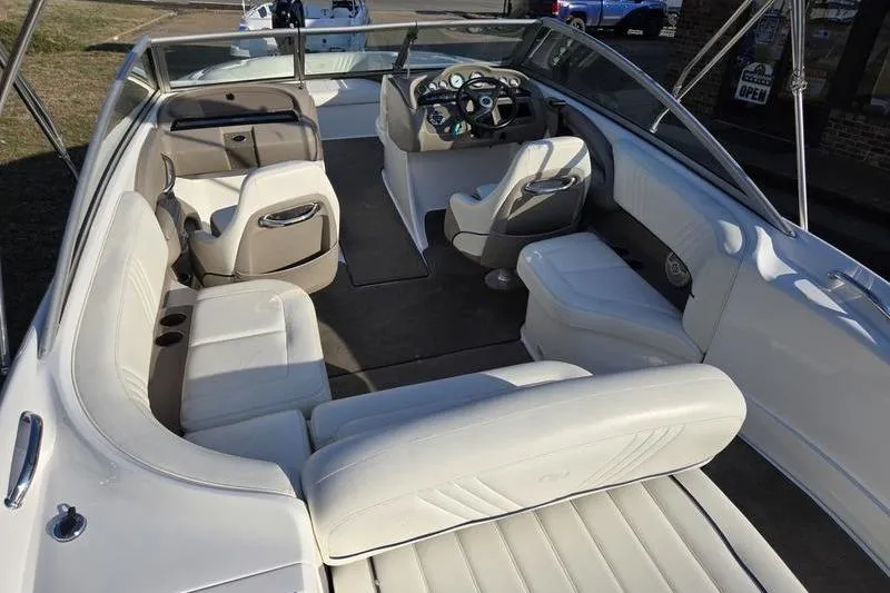 Slide: The Image of 2006 Cobalt 232 boat interior with white seating and modern dashboard. - 9