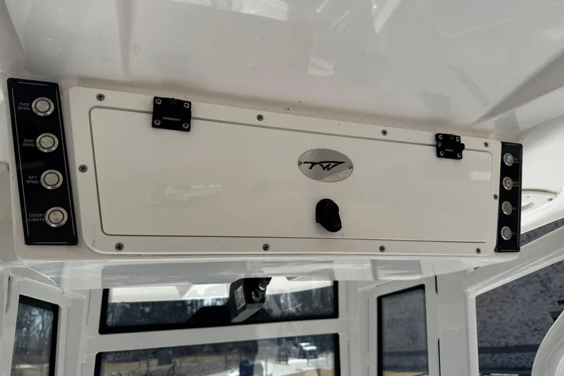Slide: The Image of 2024 Tidewater 2410 Bay Max boat console with control panel and storage compartment. - 11