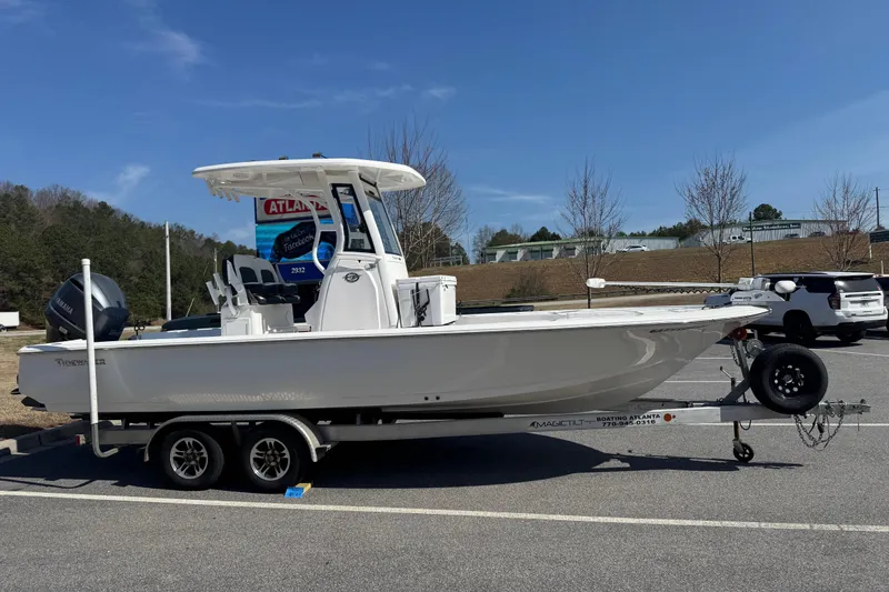 The Image of 2024 Tidewater 2410 Bay Max boat on trailer in parking lot, clear sky background. - 5