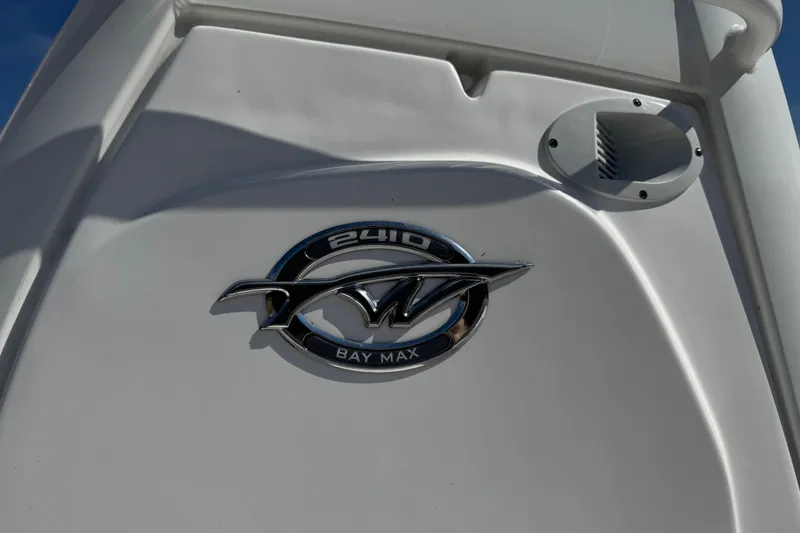 Slide: The Image of 2024 Tidewater 2410 Bay Max boat emblem on white surface. - 7
