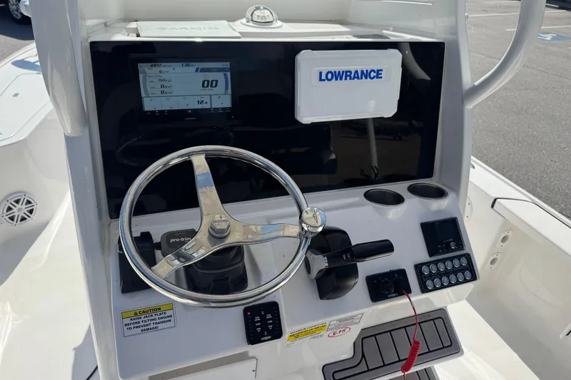 Slide: The Image of 2024 Tidewater 2410 Bay Max boat console with steering wheel and navigation equipment. - 9