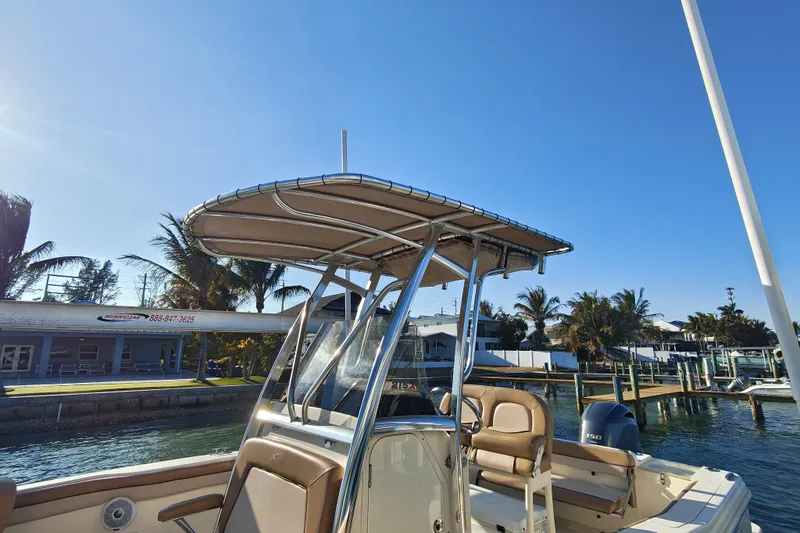 Slide: The Image of 2020 Scout 215 XSF boat docked, featuring a sleek design and sunny marina backdrop. - 15