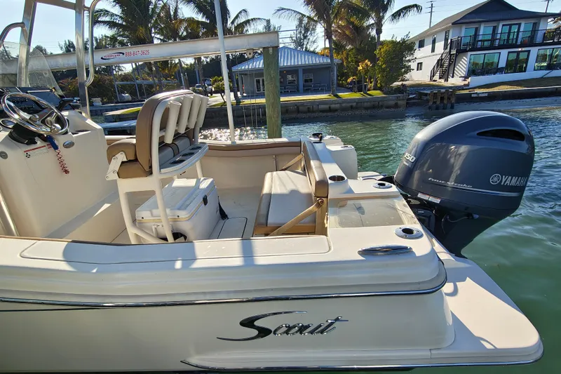 Slide: The Image of 2020 Scout 215 XSF boat with Yamaha engine docked by waterfront homes. - 21