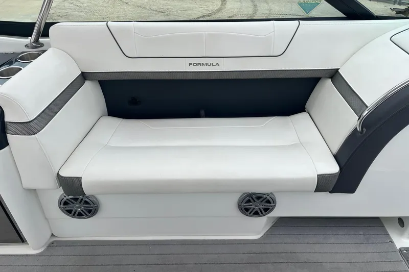 Slide: The Image of 2017 Formula 350 Crossover Bowrider interior seating with white upholstery and speaker detail. - 11