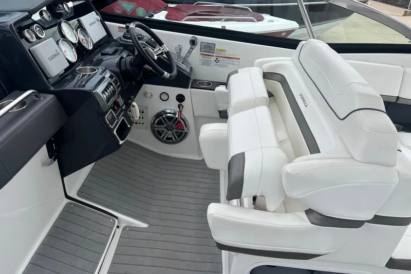 Slide: The Image of 2017 Formula 350 Crossover Bowrider cockpit with white seating and modern dashboard. - 12