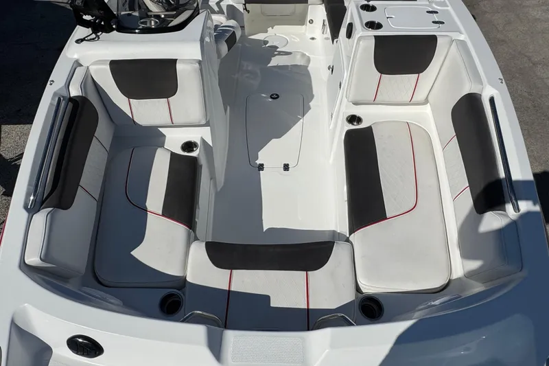 Slide: The Image of Interior of 2023 Tahoe 1950 boat with white and black seating, red accents. - 10