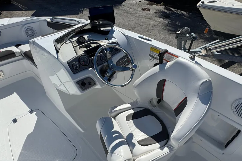Slide: The Image of Interior of a 2023 Tahoe 1950 boat featuring a sleek steering console and comfortable seating. - 11