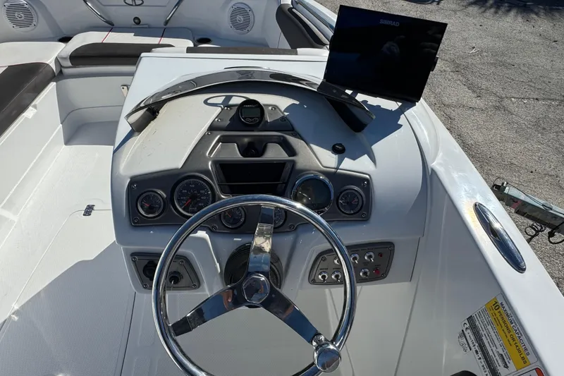 Slide: The Image of Steering console of a 2023 Tahoe 1950 boat with gauges and controls. - 12