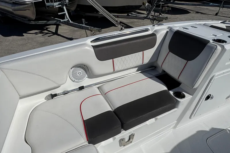 Slide: The Image of 2023 Tahoe 1950 boat interior with cushioned seating and cup holders. - 13